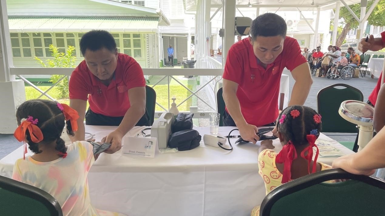 醫(yī)療隊員為福利院兒童進行檢查。第18期援圭亞那醫(yī)療隊供圖