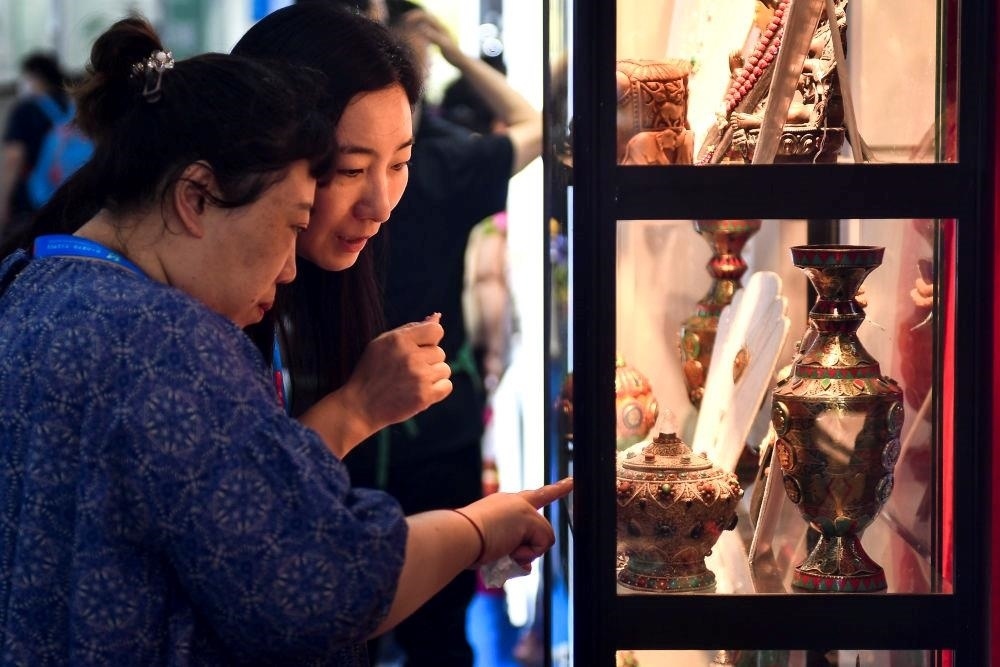 △2023年8月24日，參觀者在第十四屆中國—東北亞博覽會現(xiàn)場選購尼泊爾特色商品。