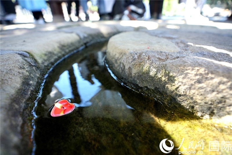 圖為水渠里流過的“桃心”蠟燭。人民網(wǎng) 盧鵬宇攝