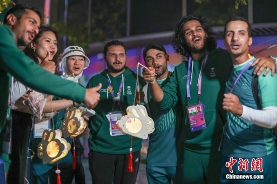 資料圖：9月29日，中國傳統(tǒng)節(jié)日中秋節(jié)，杭州亞運(yùn)會(huì)運(yùn)動(dòng)員村舉辦中秋主題活動(dòng)，中外運(yùn)動(dòng)員們歡聚一堂。圖為沙特阿拉伯運(yùn)動(dòng)員手持燈籠拍攝照片。<a target='_blank' href='/'><p align=