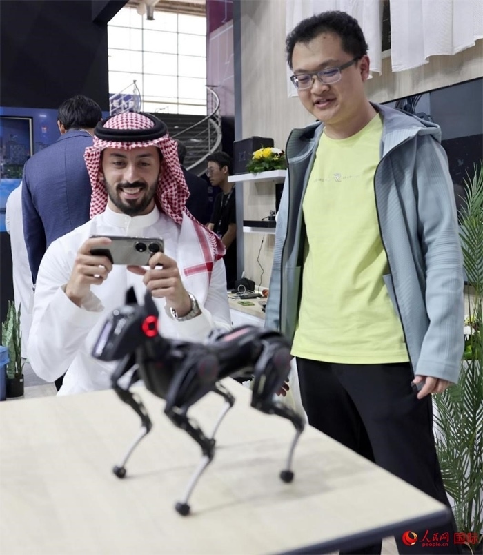 一名觀眾在體驗操作機(jī)器狗。人民網(wǎng)記者 管克江攝