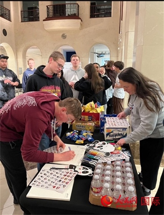 學(xué)生們出發(fā)前紛紛在留言簿留言。人民網(wǎng)記者 鄧圩攝