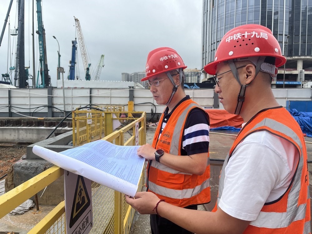 2024年4月26日，深圳市五一勞動(dòng)獎(jiǎng)?wù)芦@得者、中鐵十九局軌道公司項(xiàng)目副經(jīng)理夏荔（左）在穗莞深城際鐵路前皇段皇崗口岸站建設(shè)現(xiàn)場(chǎng)忙碌。新華社發(fā)