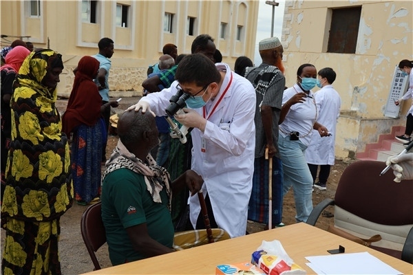 在義診現(xiàn)場，中國醫(yī)生與當(dāng)?shù)鼐用窈嫌傲裟?，吉布提鹽業(yè)投資公司供圖