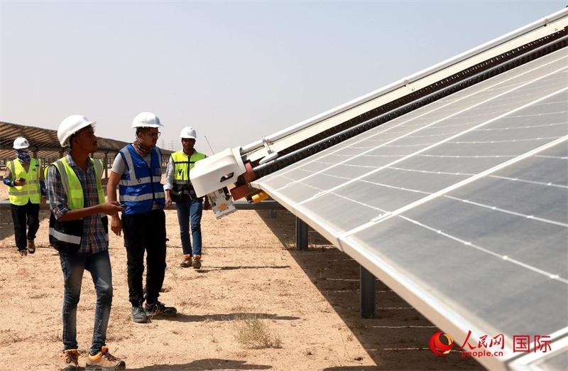 工作人員在測試自動(dòng)清掃機(jī)器人。人民網(wǎng)記者管克江攝