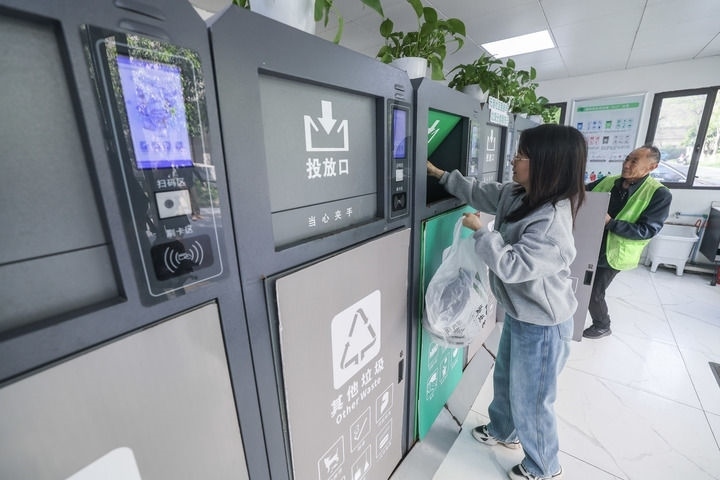 2024年4月10日，在浙江省湖州市吳興區(qū)飛英街道新華府小區(qū)內(nèi)，居民在垃圾分類智能系統(tǒng)的指導(dǎo)下進(jìn)行垃圾分類投放，居民的投放情況將實時匯總到智慧服務(wù)平臺，會有相應(yīng)的積分獎勵。新華社記者 徐昱 攝