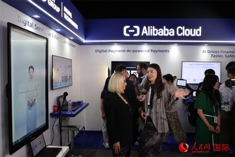 當?shù)孛襟w在2025迪拜金融科技峰會的一家中資企業(yè)展廳采訪，張志文攝